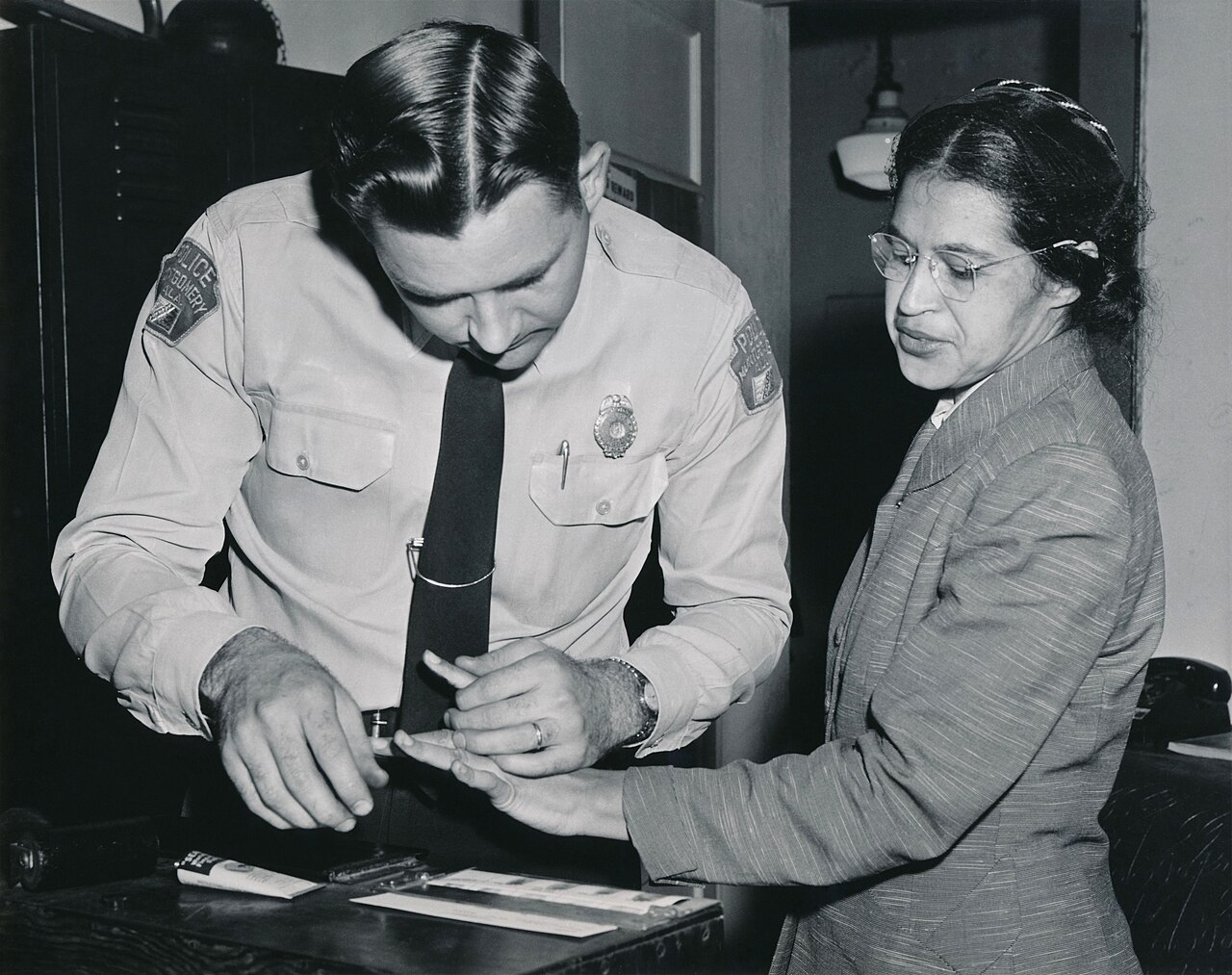 Rosa Parks being fingerprinted by Deputy Sheriff D.H. Lackey after her arrest during the Montgomery Bus Boycott, February 22, 1956.